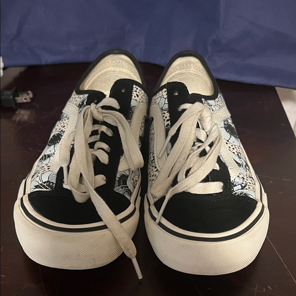 Floral Black and White Vans with light blue background color on the sides.